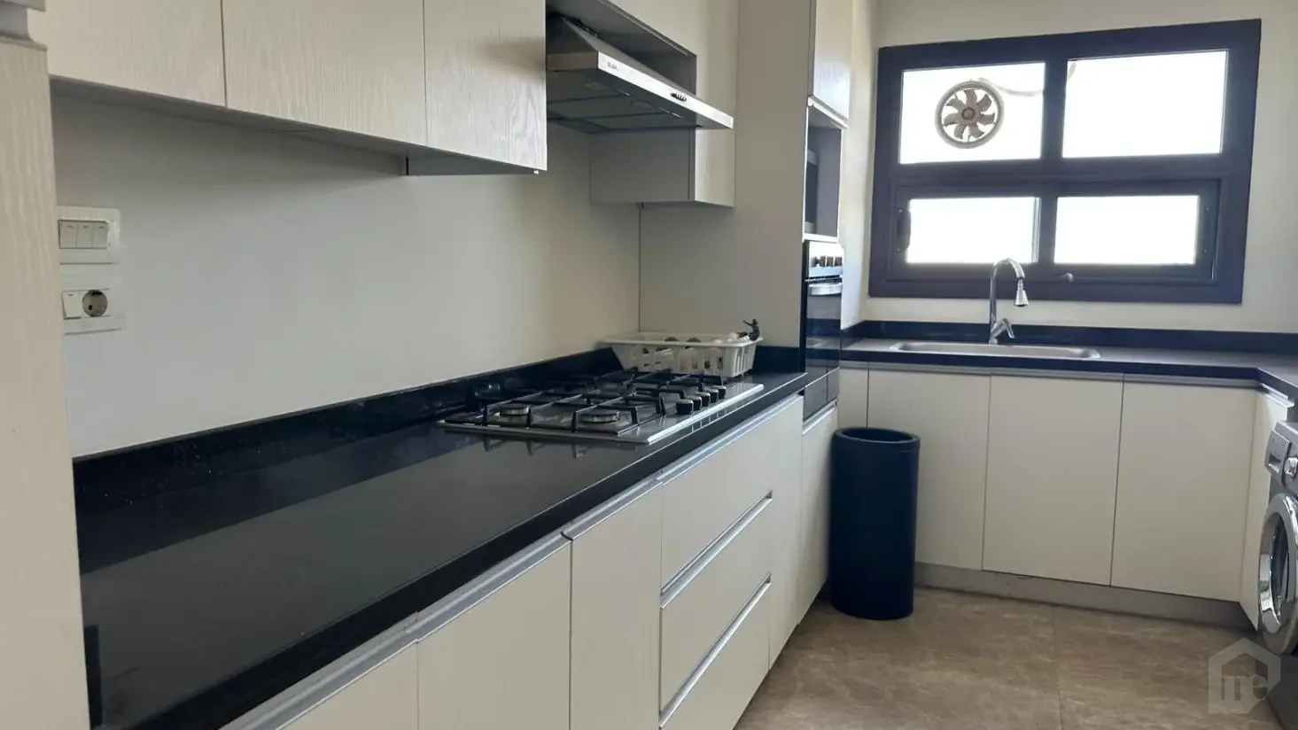 Elegant kitchen design with natural light in an apartment for sale in Mivida