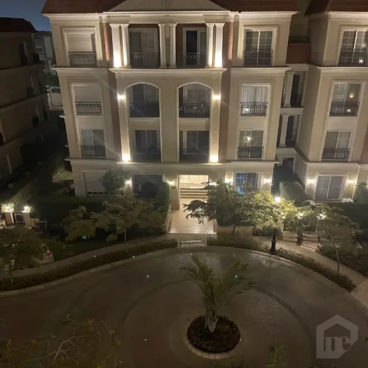 Apartment for sale in Regents New Cairo building exterior at night