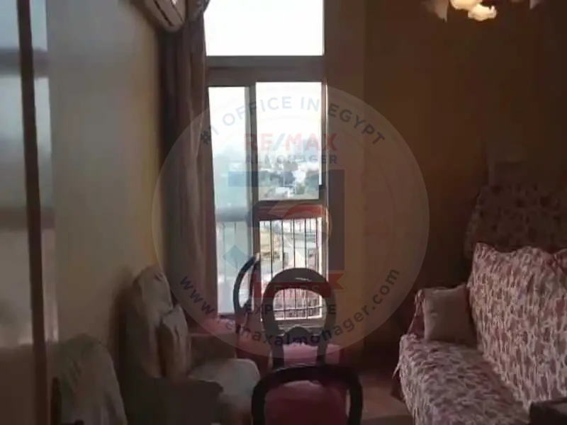 Seating area near window in Obour Buildings apartment