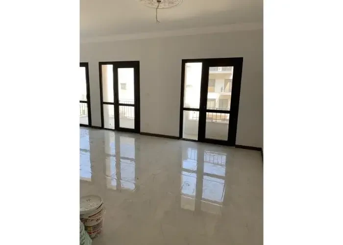 Room with balcony doors in Sodic East Town apartment for sale