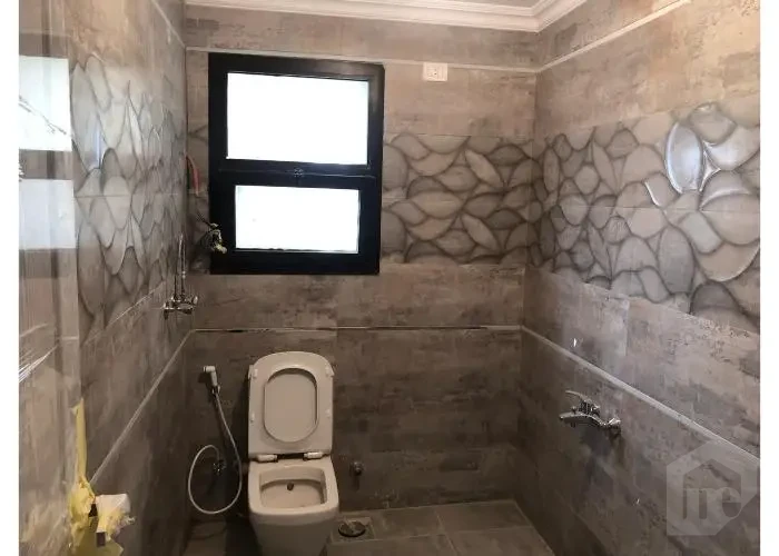 Bathroom with window in Sodic East Town apartment for sale