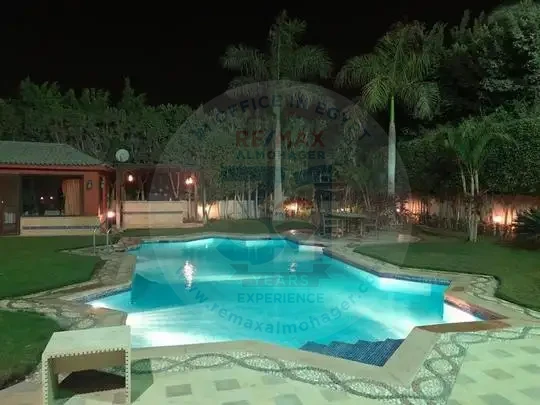 Villa for sale in Sheikh Zayed illuminated swimming pool and garden in Tara Compound