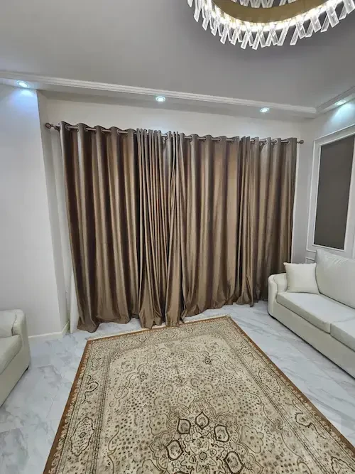 Furnished rental apartment in Patio Oro living room with curtains