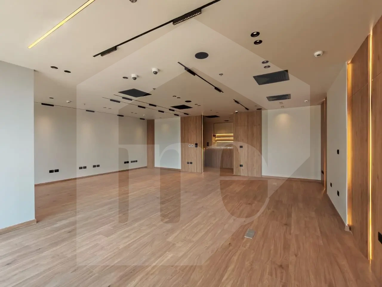 Bright administrative office for sale in Mivida Park with floor-to-ceiling windows.