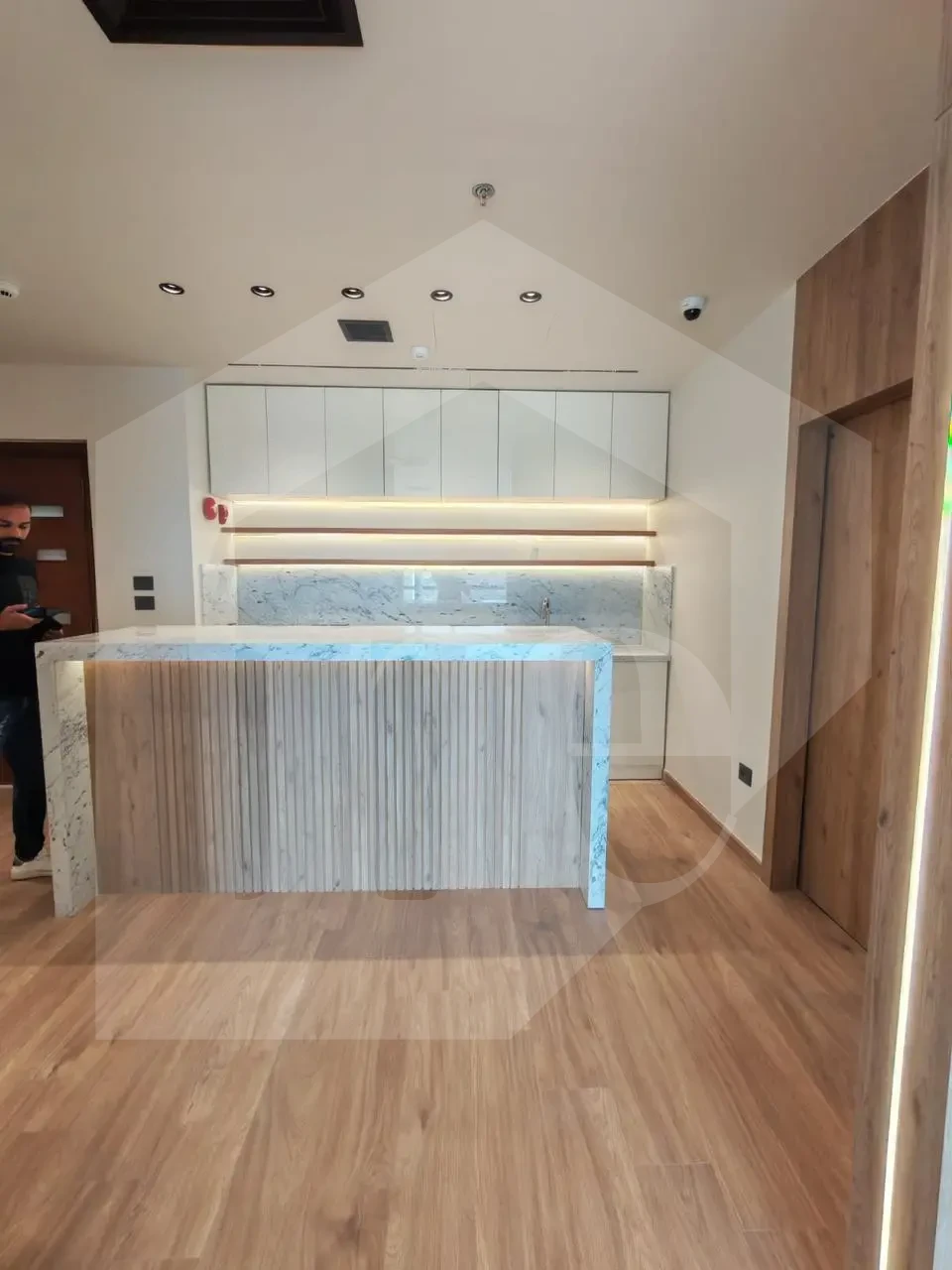 Grand entrance for an administrative office for sale in Mivida Park, marble & wood.